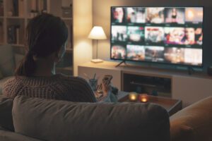 A woman browsing Youtube TV from her couch.